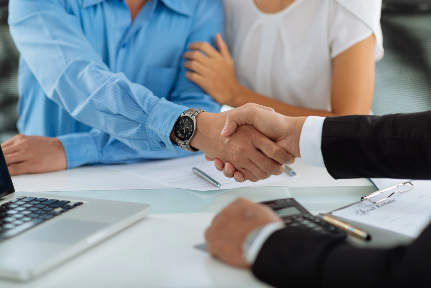 Real estate agent shaking hands with client